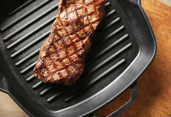Grilled steak on grill pan, closeup