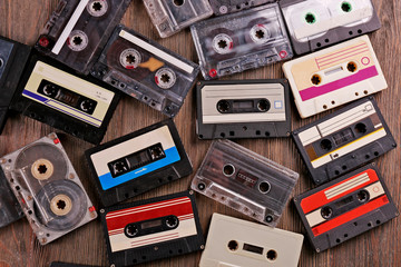 Set of old audio cassettes on wooden background