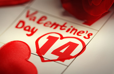 Calendar with date of February 14 and rose flower petals. Valentines day concept