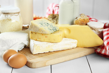 Set of fresh dairy products on white wooden table