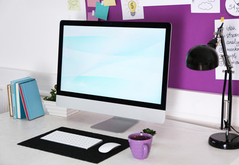 Stylish workplace with computer and interior decorations