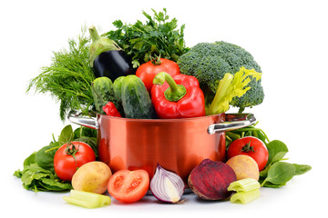 Pot and raw vegetables isolated on white.