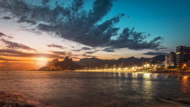 Sunset behind the mountains on Ipanema Beach, Rio de Janeiro