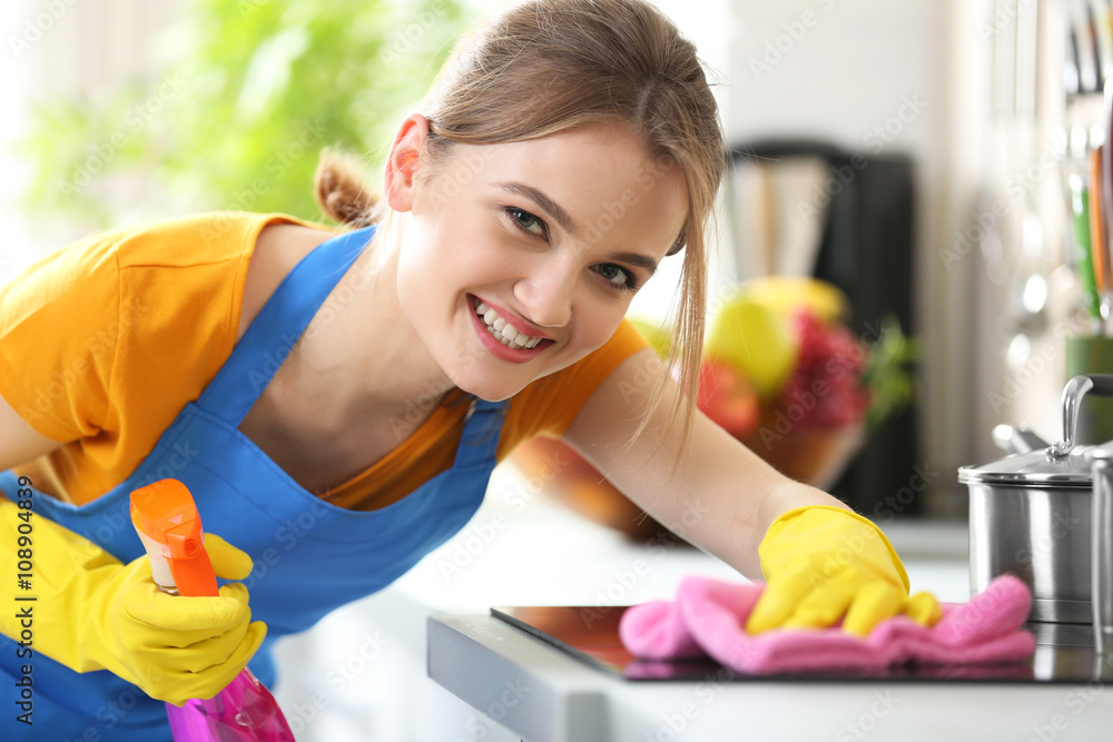 Wall mural Cleaning concept. Woman washes an oven, close up