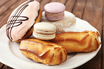 Plate of cakes on wooden background