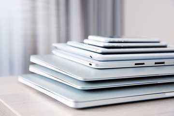 Stack of electronic device on wooden table