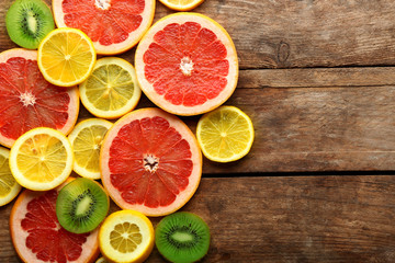 Fototapeta na wymiar Fresh sliced citrus on wooden background