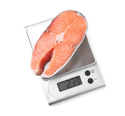 Row salmon steak on digital kitchen scales, isolated on white