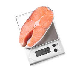 Foto auf Acrylglas Row salmon steak on digital kitchen scales, isolated on white © Africa Studio