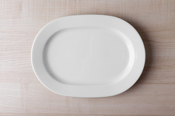 Empty plate on wooden background