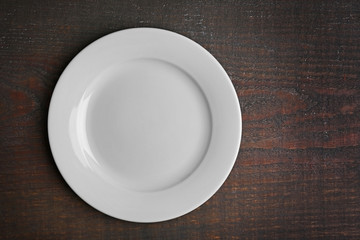 Empty plate on wooden background