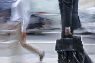 motion blurred business people walking on the street