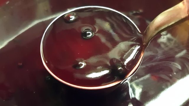 Blending fresh, purple blueberry kissel, inside a big pot
