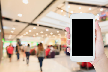 hand hold mobile phone with blurred shopping mall