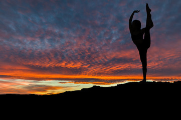 Silhouette of Woman Dancing Outdoors at Sunset