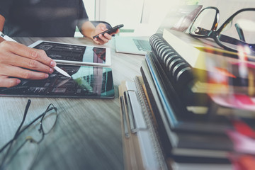 designer hand working with digital tablet and laptop computer an