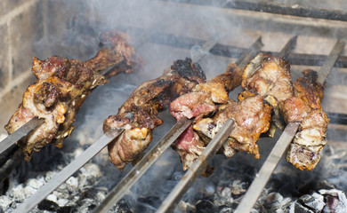 Grilling shashlik on barbecue grill. Cooking meat on skewers in the brazier.  