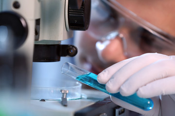 Serious clinician studying chemical element in laboratory