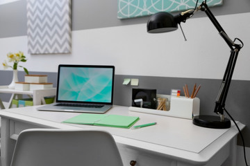 Stylish workplace with laptop at home