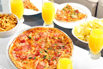 Table at home with pizza and drinks for friends