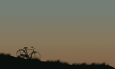 Fototapeta premium Silhouette of bike in fields