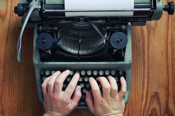 typewriter retro hand on wooden table