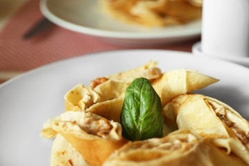 Tasty pancakes on plate in cafe, close up