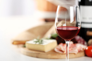 Glass of wine with food on table closeup