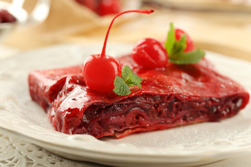 Cherry strudel with mint on plate