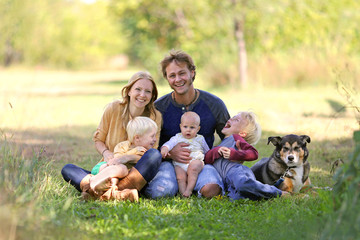 Happy Laughing Family of 5 People and Dog in Sunny Garden