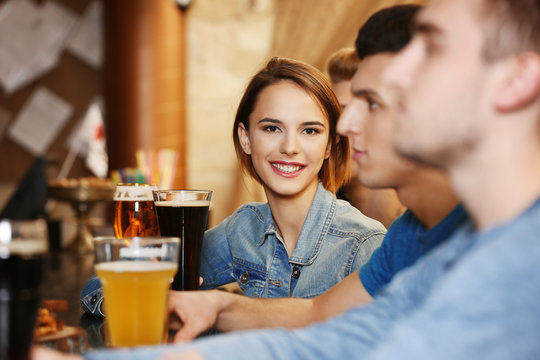 Group of young people spending time in bar