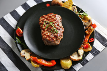 Delicious grilled steak with vegetables on plate