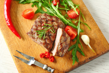 Delicious grilled steak on cutting board