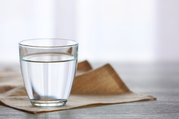 Glass of fresh water on wooden table
