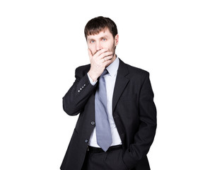 gestures distrust lies. body language. man in business suit, hand closes his lips. isolated on white background. concept of true or false