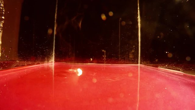 Sodium Ball Dipped With Tweezers Into Red Liquid and Adjusts Its Movement