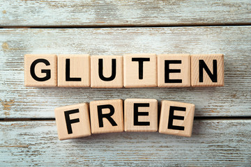 Gluten-free diet concept. Cubes on wooden background