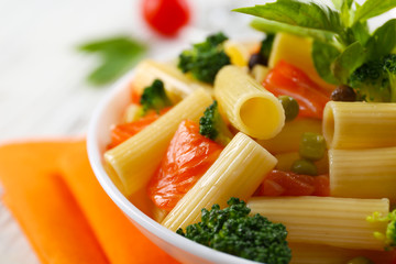 Obraz na płótnie Canvas Plate of pasta with salmon and broccoli on table closeup