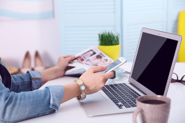 Blogging concept. Woman using her phone.