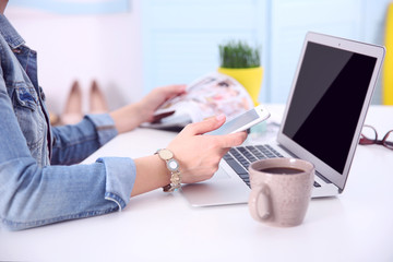 Blogging concept. Woman using her phone.
