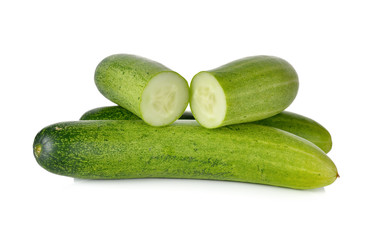 whole and cut fresh cucumbers on white background
