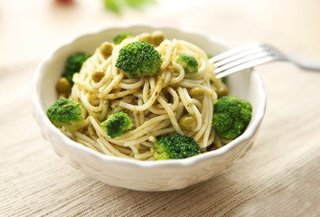 Delicious cold pasta salad in bowl on the table closeup