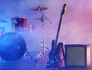Fototapeta na wymiar Rock band instruments on foggy background