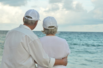 elderly couple rest at tropical beach