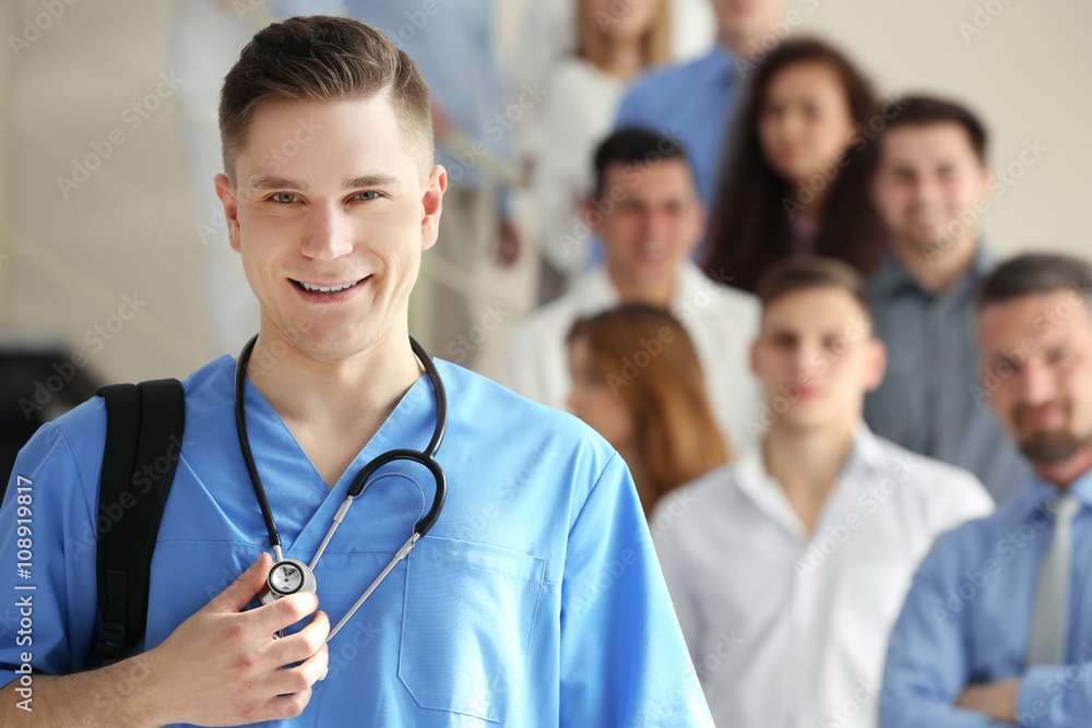 Poster A medical student and group-mates standing in the university