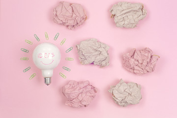 great idea concept with crumpled colorful paper and light bulb on light background