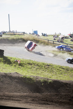 Cars racing on dirt road