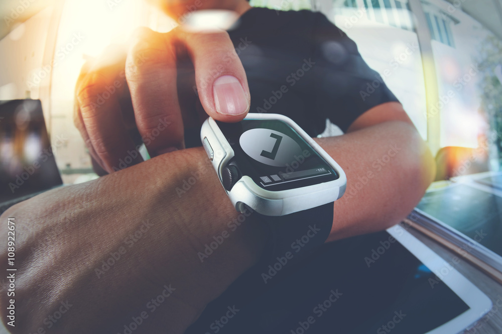 Poster website designer working with smart watch and digital tablet and