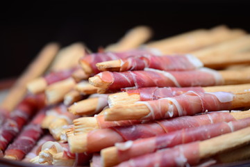 Appetizer, grissini with prosciutto crudo