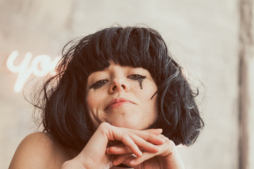 The tear-stained girl with the begun to flow ink, smiling